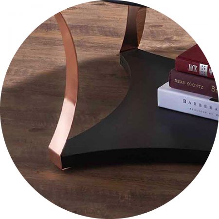 The black glass desktop and the rose gold table feet are connected.